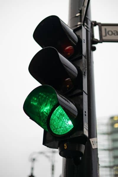 Smart traffic signal with green light and pedestrian arrow in Huntsville, demonstrating advanced traffic engineering technology.
