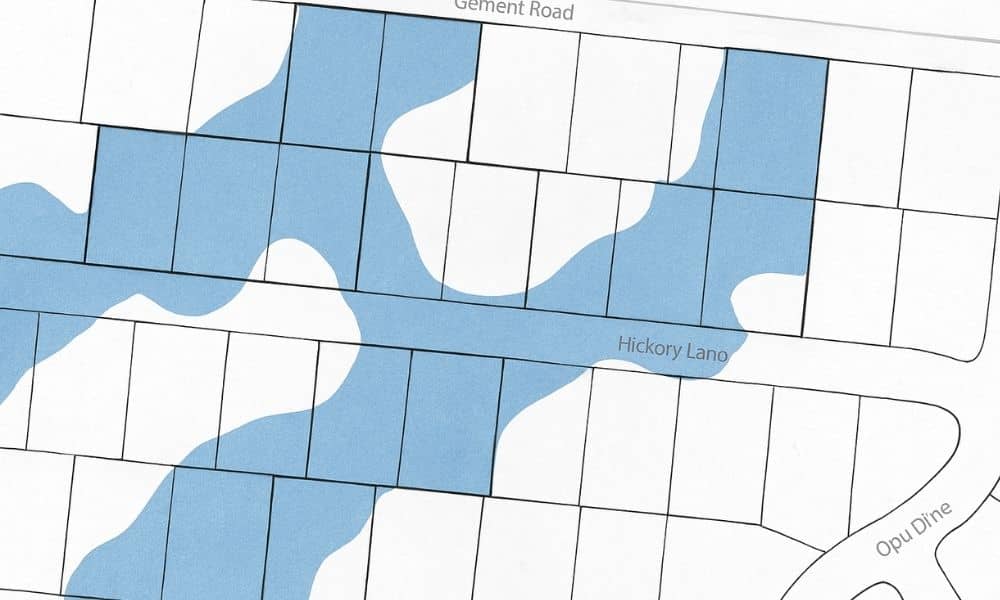  FEMA-style flood map overlay with property survey parcel lines showing high-risk flood zones
