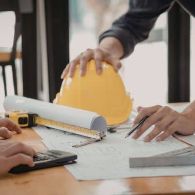 Engineers reviewing site plans and terrain details using lidar mapping during early flood risk planning
