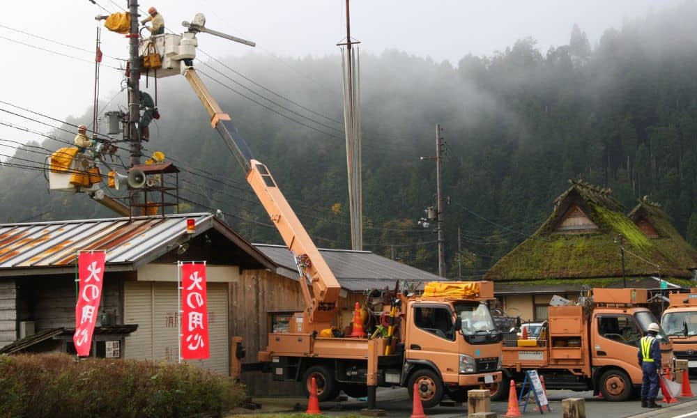 Utility crews working near a home, showing why a mortgage survey often misses easements that allow access to a property