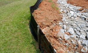 Erosion control barrier along a construction site showing how construction survey accuracy supports stormwater compliance