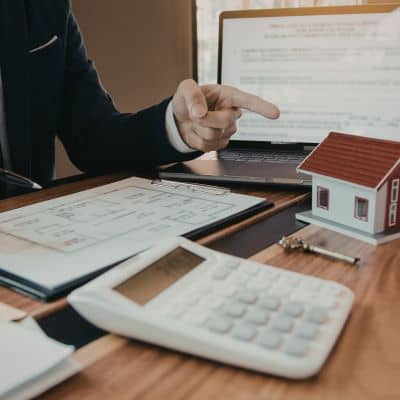 Reviewing property documents and plans as part of a boundary survey before starting construction