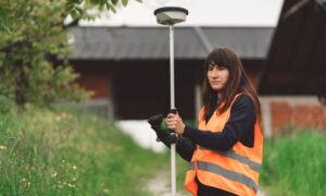 A land survey company using GPS equipment to locate a boundary marker before setting property lines