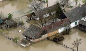 Residential flooding poor drainage aerial view - ALTA Survey Alabama Aerial view of residential homes surrounded by floodwater, showing how a topo survey helps identify low-lying areas and drainage issues
