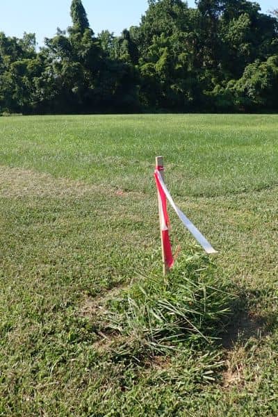 Property boundary marker placed during a residential land survey to verify property lines