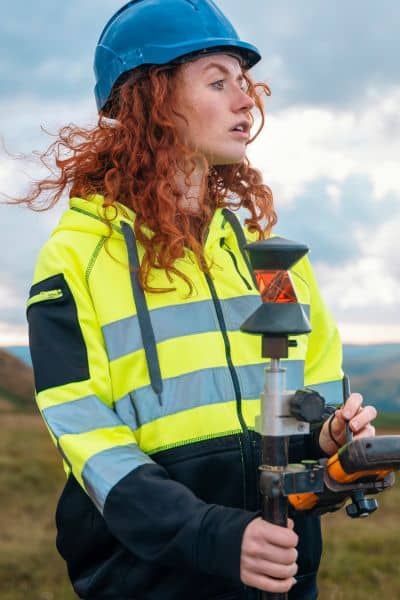 Surveyor using GPS equipment to mark and confirm property boundaries on site
