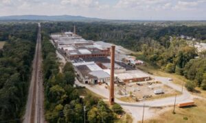 Aerial view of an industrial facility and active rail line where LiDAR mapping supports rail spur extension planning