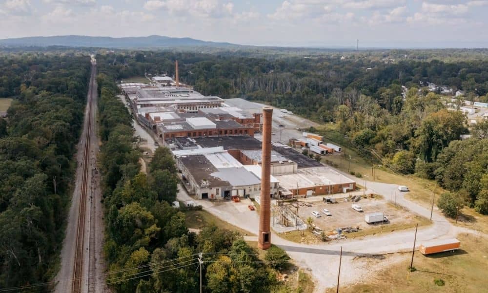 Aerial view of an industrial facility and active rail line where LiDAR mapping supports rail spur extension planning