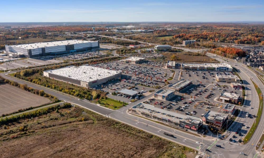 Aerial view of several commercial properties with multiple buildings, parking areas, and shared access roads
